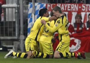 Borussia Dortmund's Barrios, Zidan and Bender celebrate goal against Bayern Munich during German Bundesliga soccer match in Munich